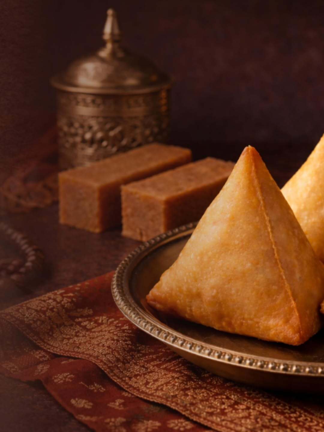 A bite that begins with a crunch and ends in nostalgia. Golden samosa perfection folded with love.